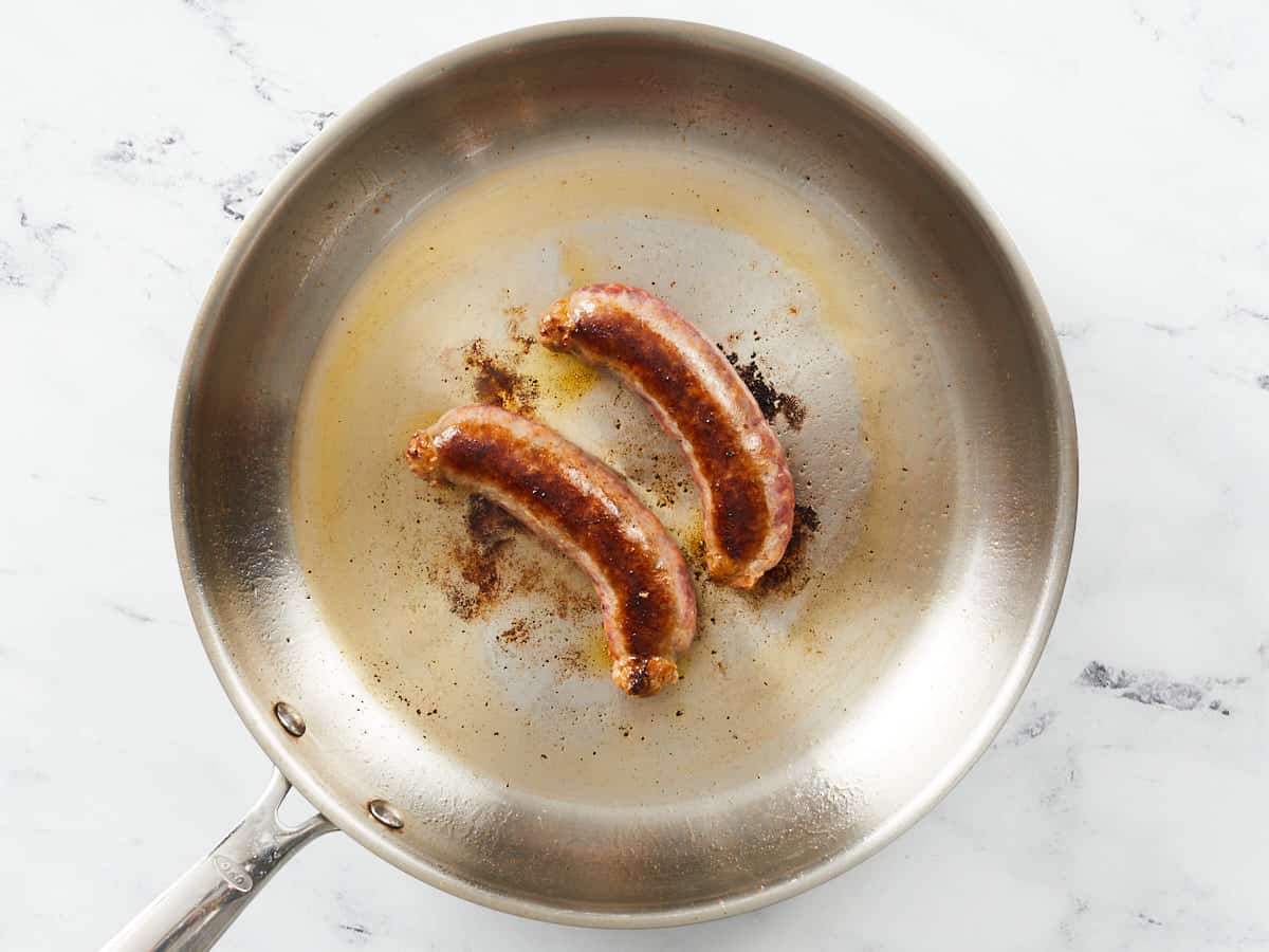 Cooked sausage links in a skillet.