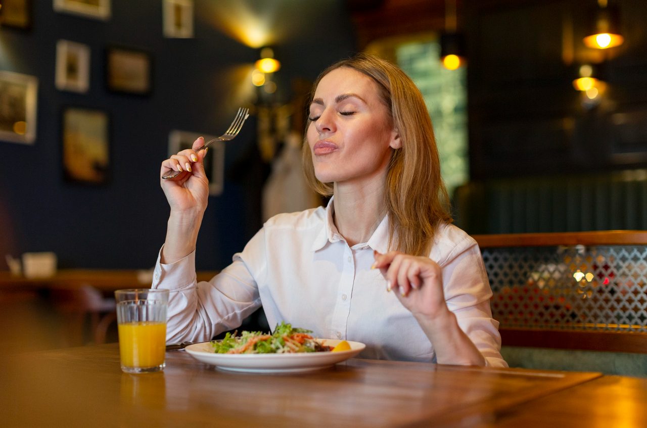 Woman enjoying a meal at a restaurant