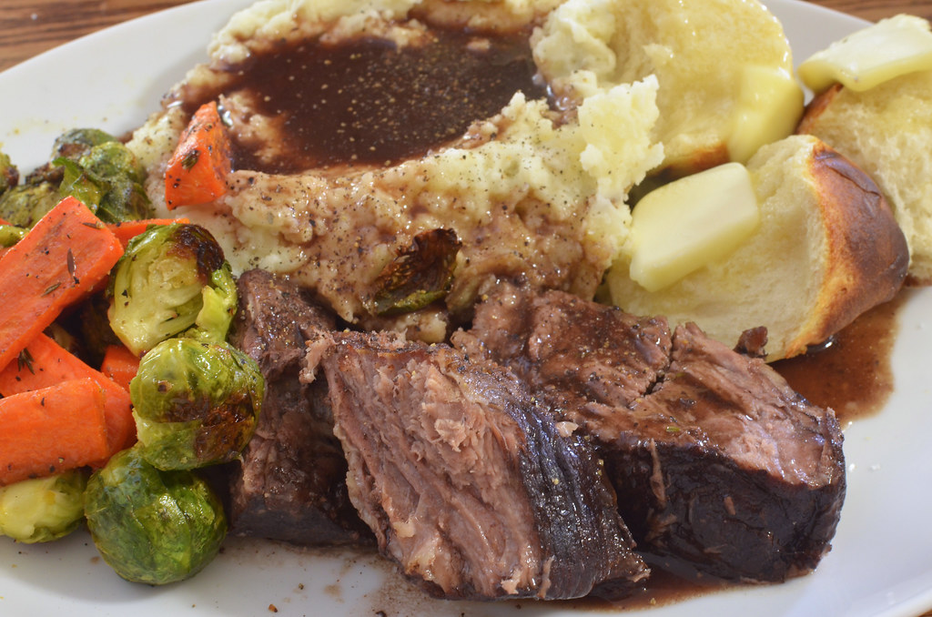 Beef braising in a dark red chile broth in a heavy pot