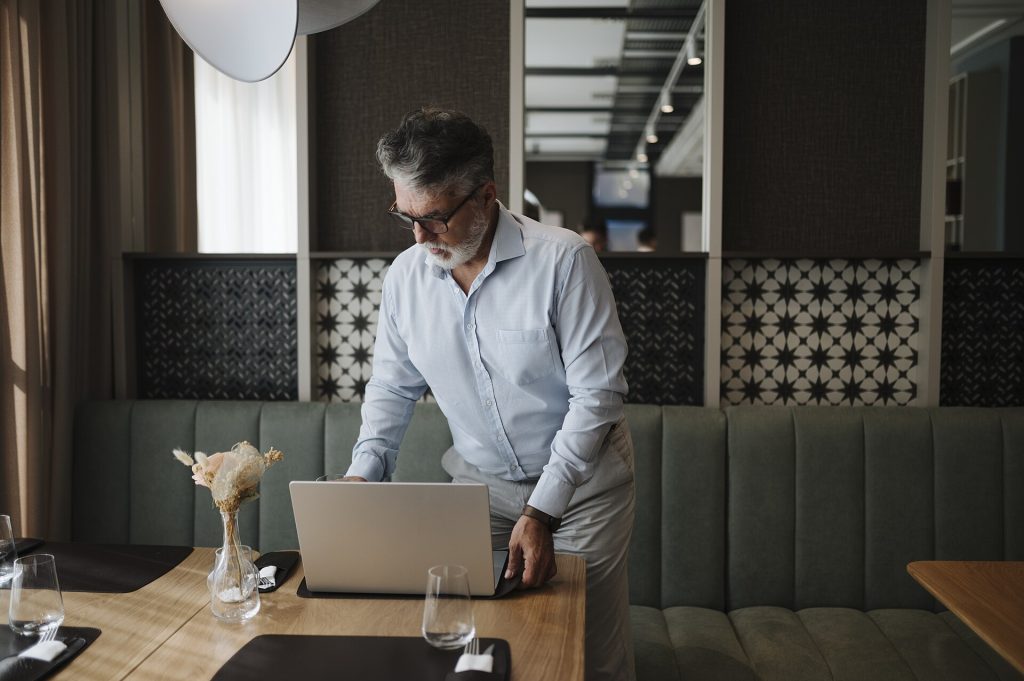 Businessman working on laptop in a modern restaurant