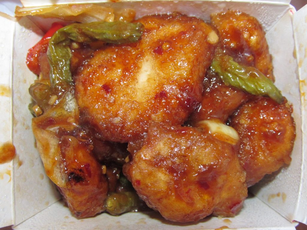 A plate of crispy General Tso's chicken with glossy sauce
