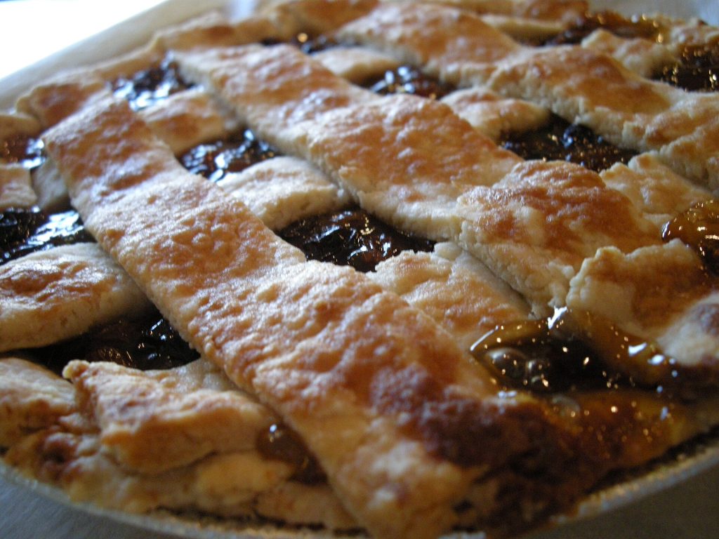 A golden baked fruit pie with a lattice top crust