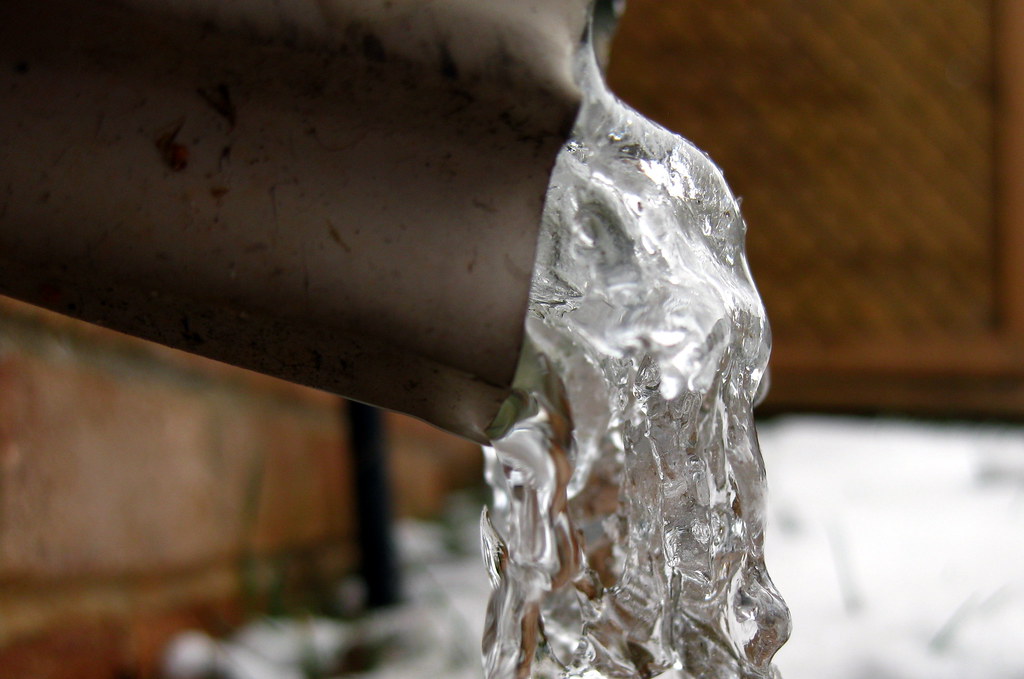 Ice forming on an exposed pipe in freezing weather