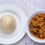 Fufu served in a bowl alongside West African soup