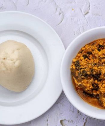Fufu served in a bowl alongside West African soup