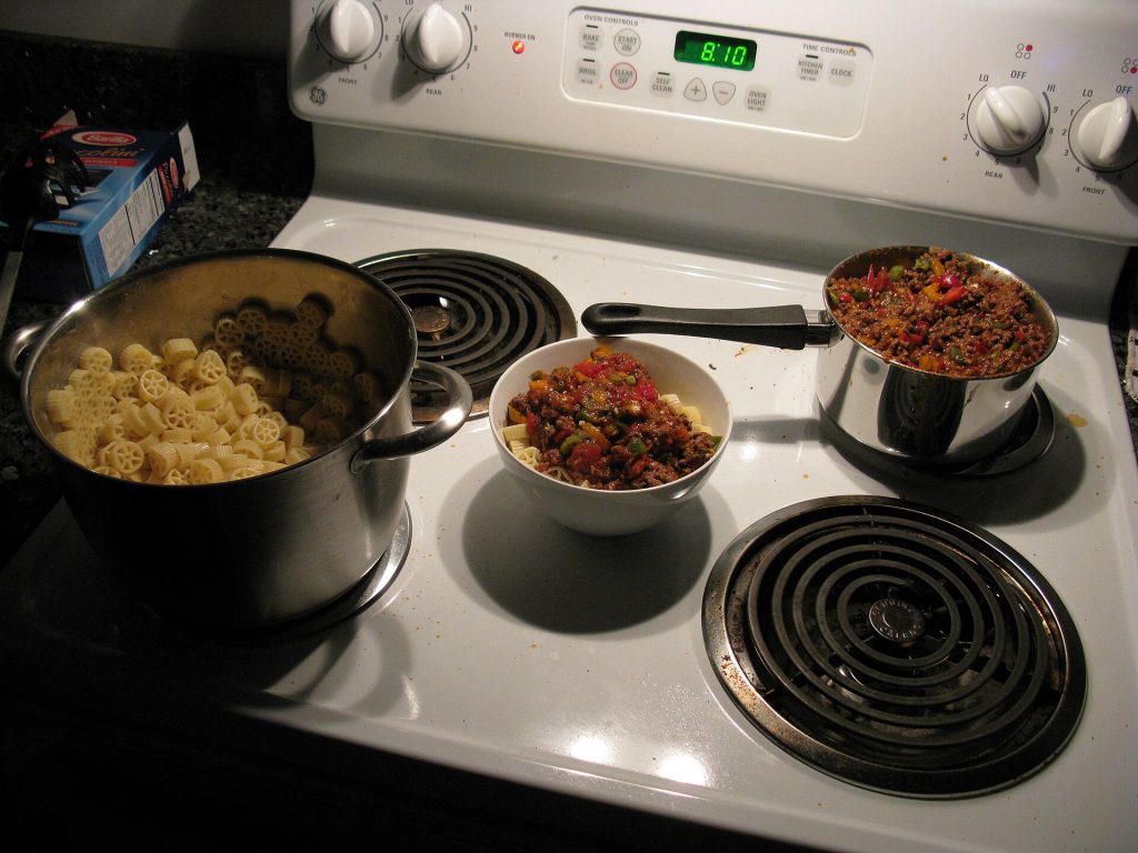 A pot of homemade chili simmering on a stove