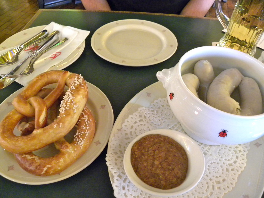 Pretzel and sausages served with beer