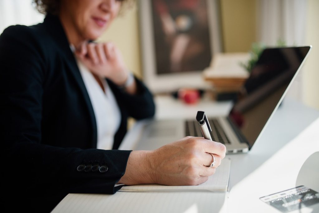 Taking notes at a laptop