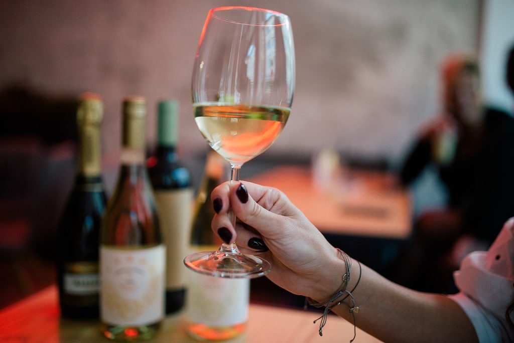 A glass of white wine on a restaurant table