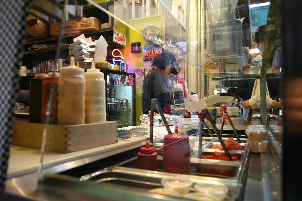 Takeout containers lined up on a restaurant counter