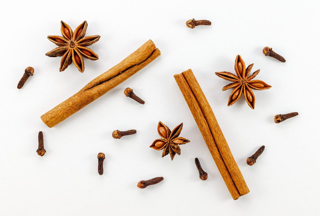 Cinnamon sticks, star anise and cloves on a wooden board