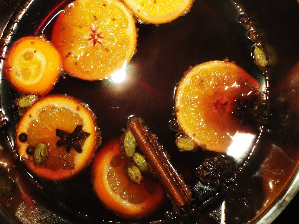 A pot of mulled wine with orange slices and whole spices