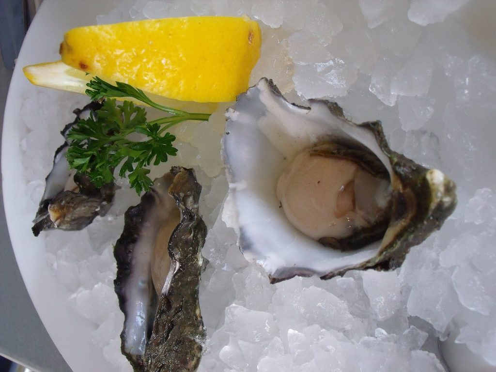 Fresh oysters on the half shell served on crushed ice